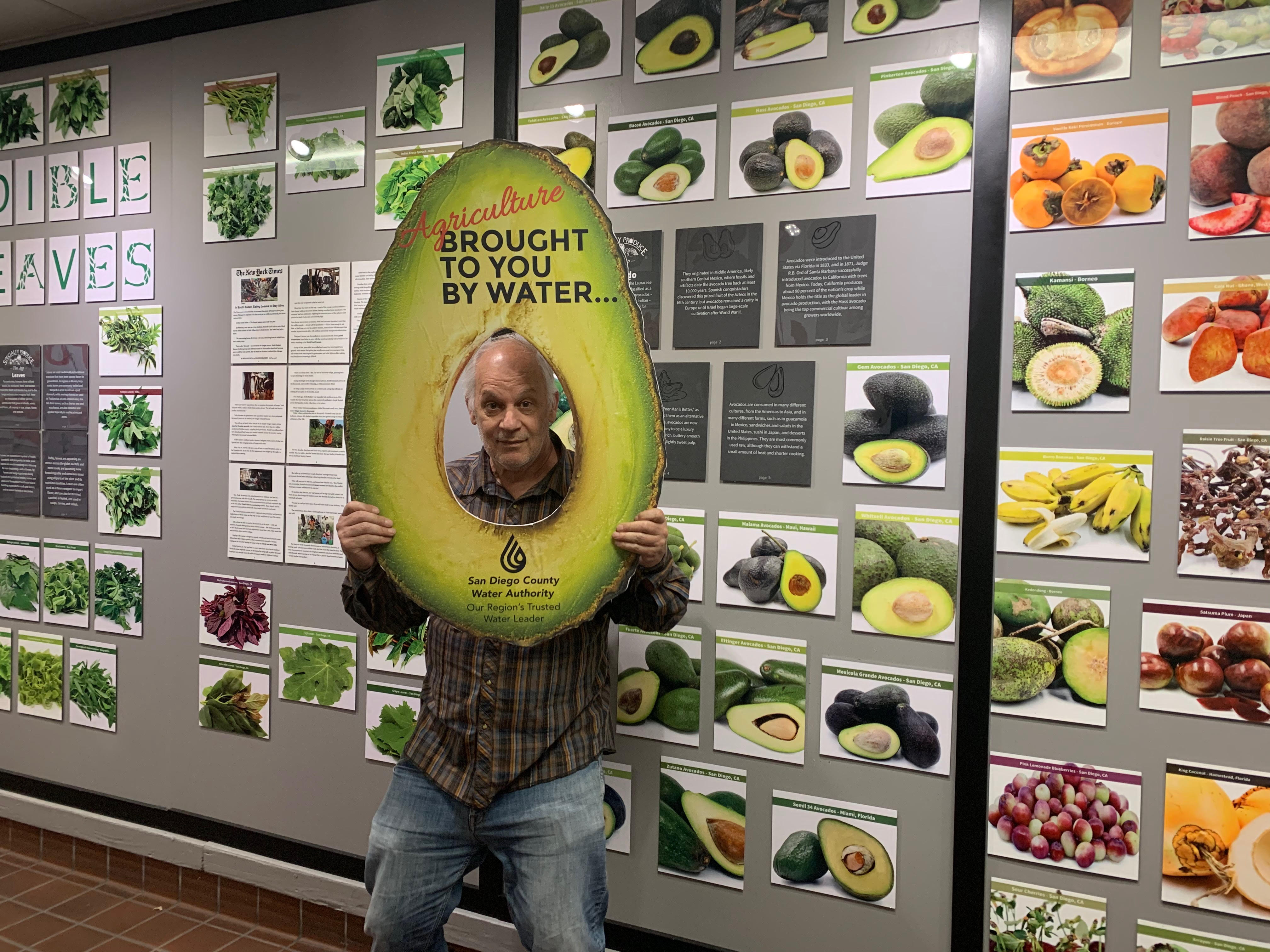 Man posing with acovado prop.