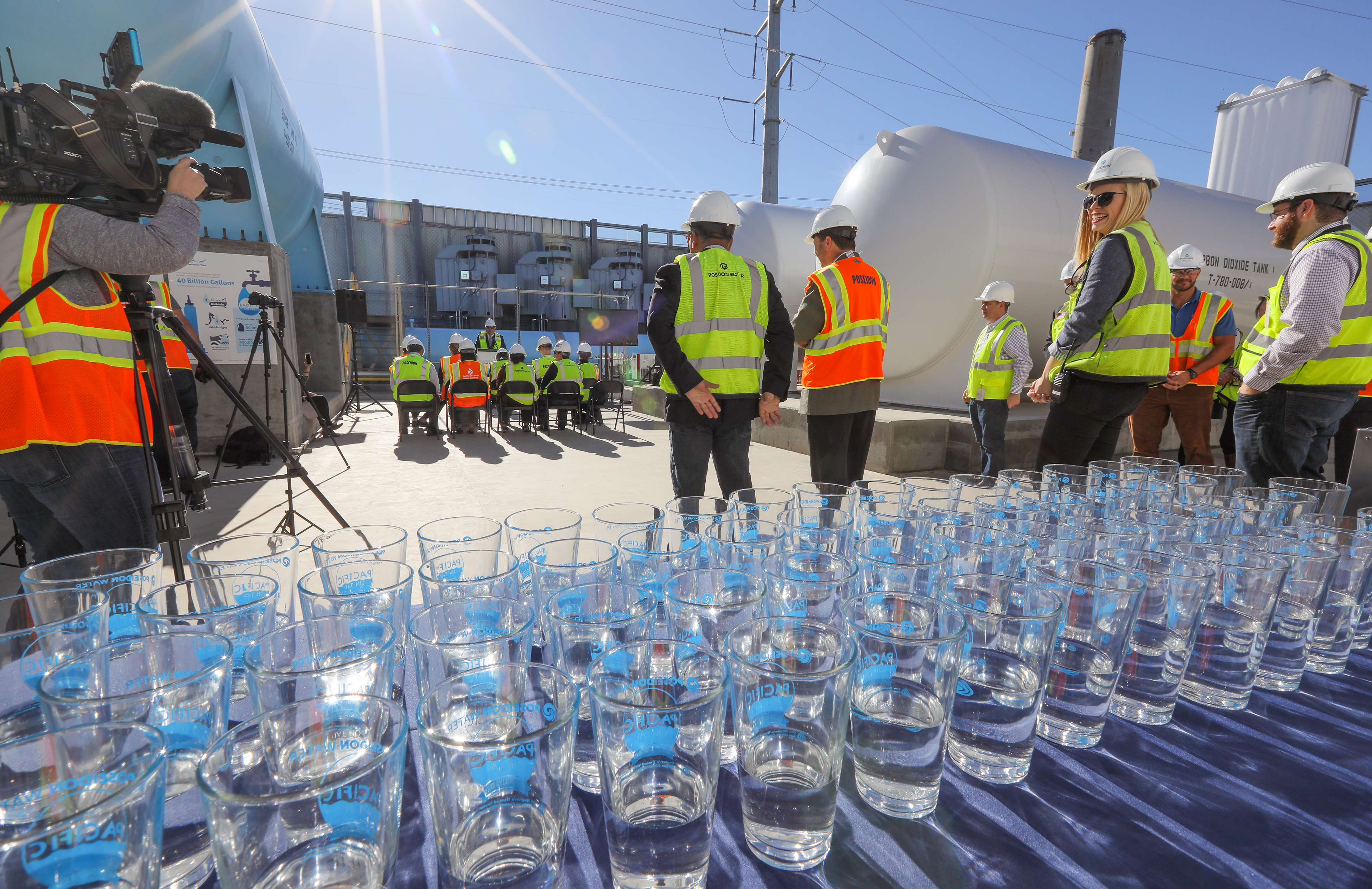 Construction workers gathering to commemorate the desalination of water via the Carlsbad plant.