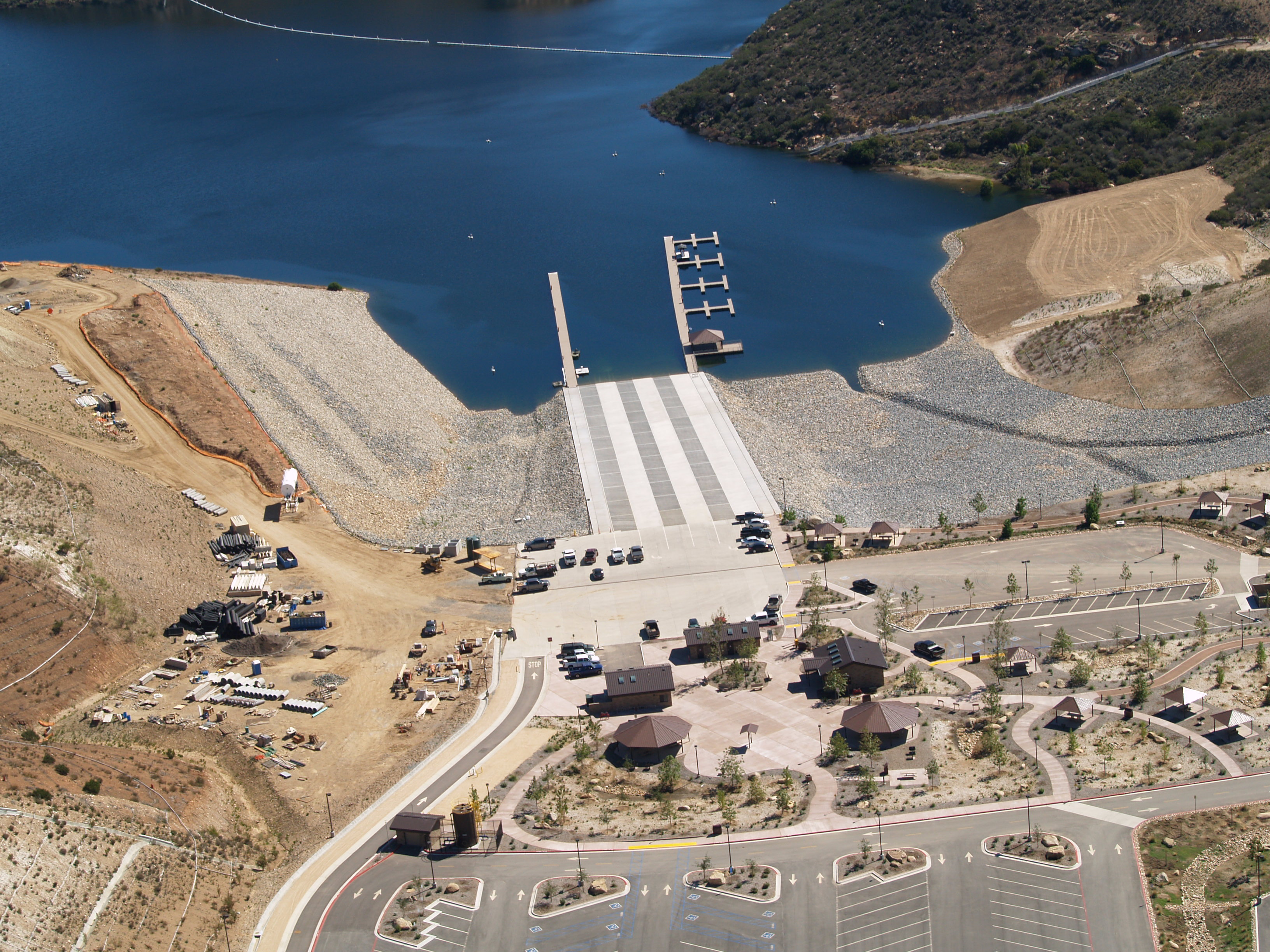 An aerial shot of a lake with the new boat ramp and docking area.