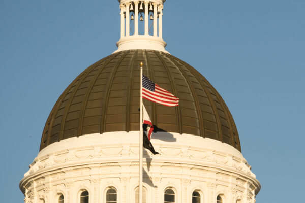 california state building with flags waving