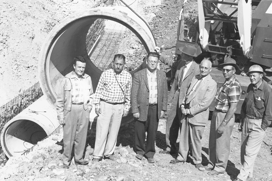 men standing in front of pipeline 3 for a picture